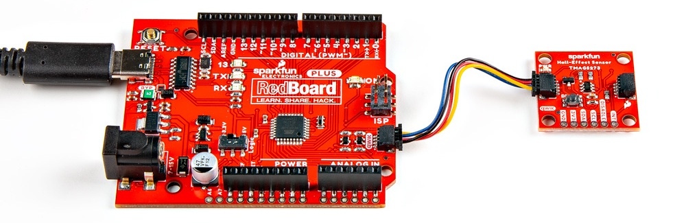 The Qwiic Hall-Effect Sensor is connected to a RedBoard Plus, with a Qwiic cable.