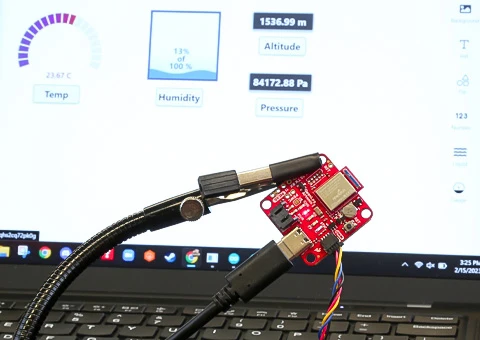 Data Logger board with data on a computer in the background